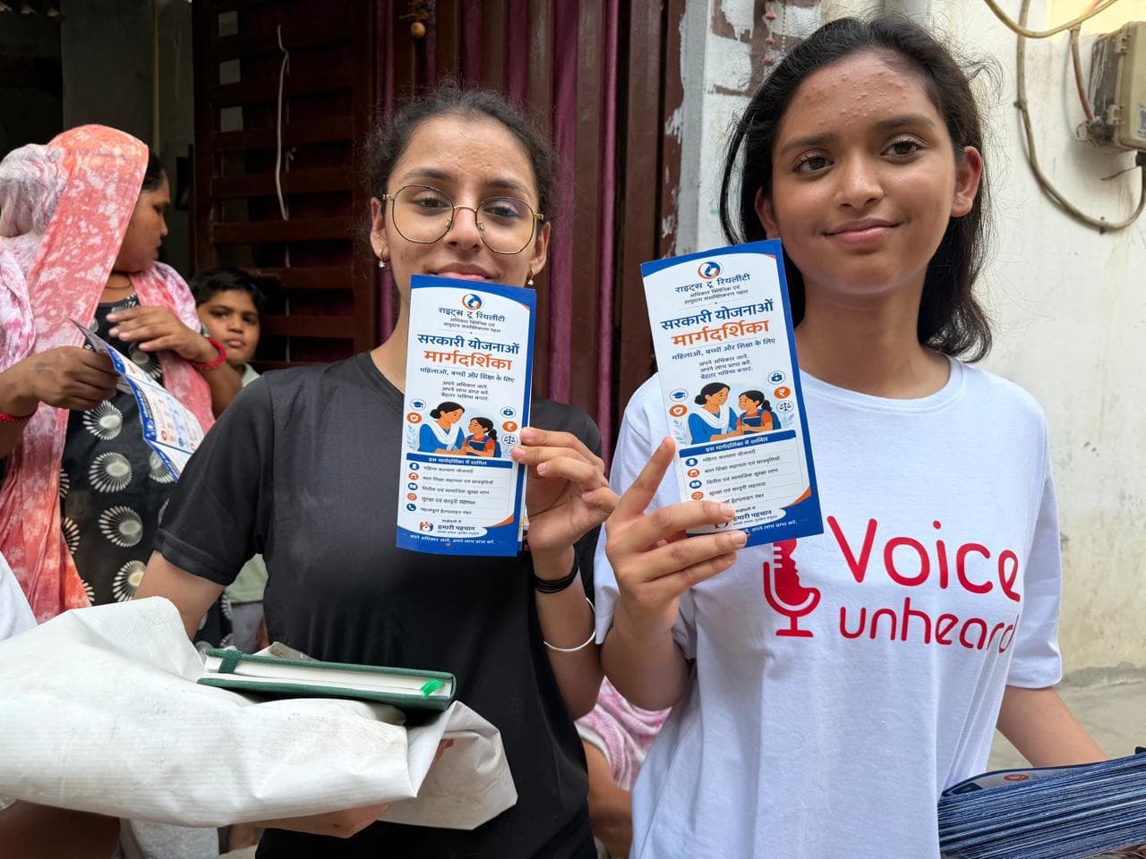 Srishti Aggarwal presenting the Rights to Reality government welfare scheme guides during on-ground outreach